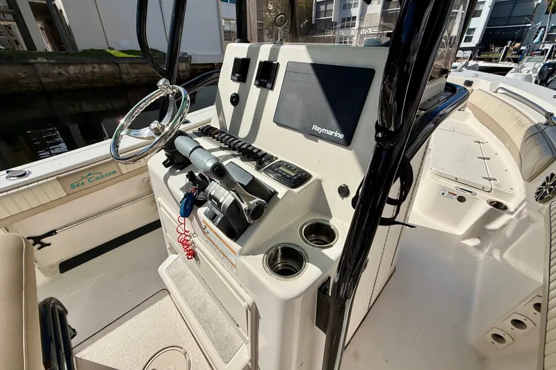 Slide: The Image of 2018 Sea Chaser 24 HFC boat console with steering wheel and navigation equipment. - 17