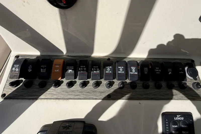 Slide: The Image of Control panel of a 2018 Sea Chaser 24 HFC boat with labeled switches. - 18