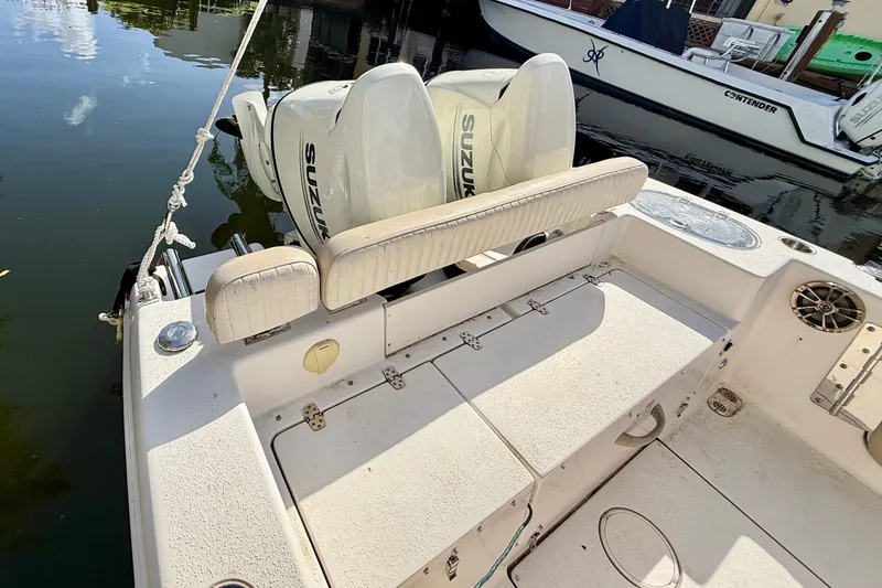 Slide: The Image of 2018 Sea Chaser 24 HFC boat with Suzuki engines docked by the water. - 25