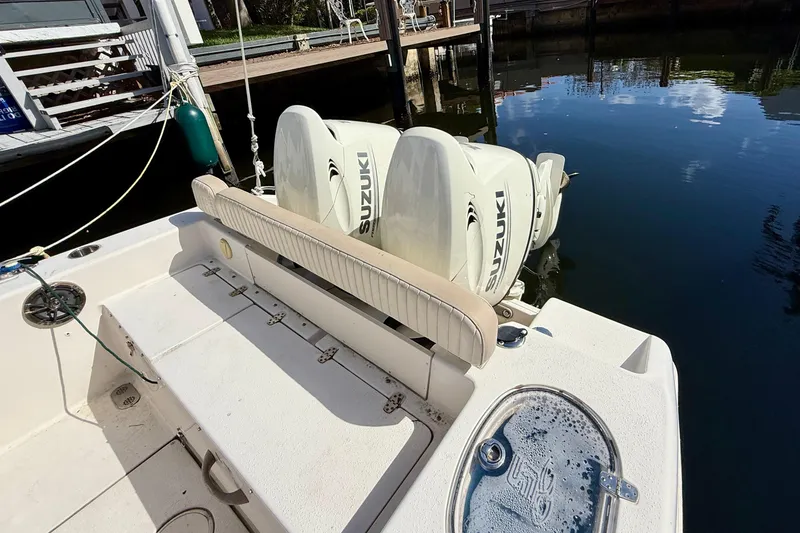 Slide: The Image of 2018 Sea Chaser 24 HFC boat with Suzuki outboard engines docked by the water. - 26