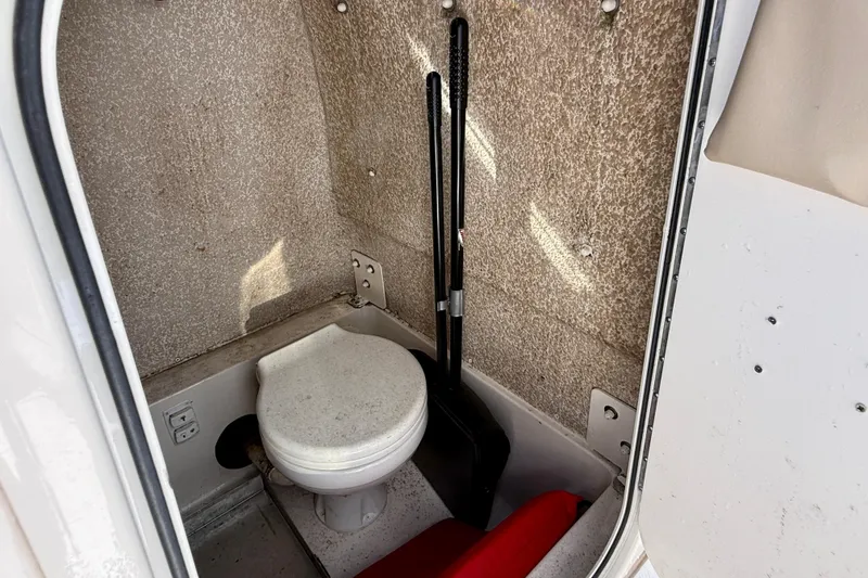 Slide: The Image of 2018 Sea Chaser 24 HFC boat interior with compact marine toilet. - 28