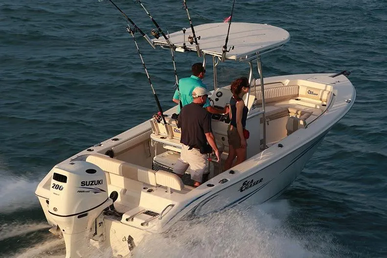 Slide: The Image of 2018 Sea Chaser 24 HFC boat docked in marina, featuring spacious seating and modern design. - 4