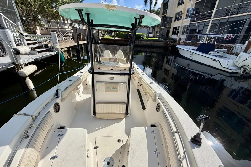 Slide: The Image of 2018 Sea Chaser 24 HFC boat docked in a marina, showcasing spacious interior. - 7