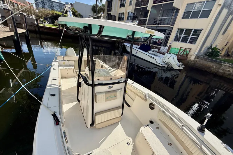 Slide: The Image of 2018 Sea Chaser 24 HFC boat docked near waterfront buildings. - 8