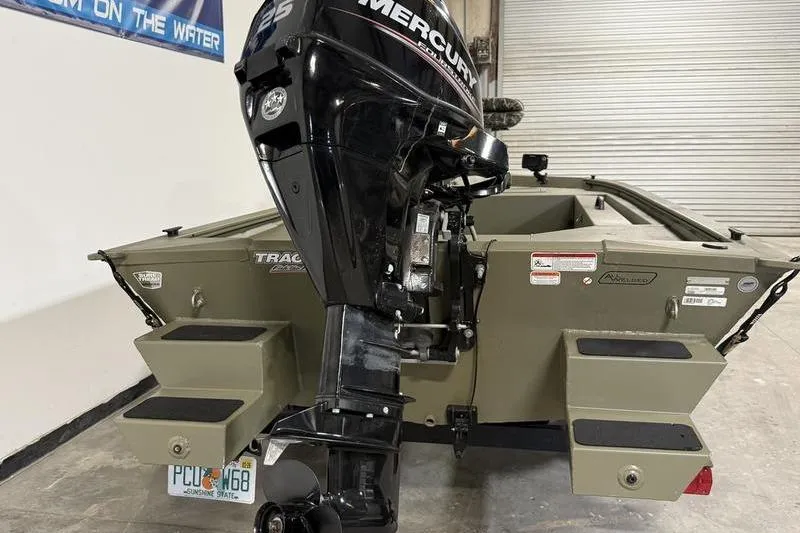 Slide: The Image of 2020 Tracker Grizzly 1548 T boat with Mercury outboard motor in a garage setting. - 4