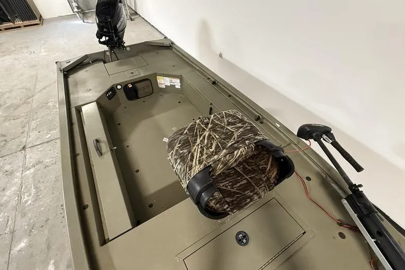 Slide: The Image of 2020 Tracker Grizzly 1548 T boat interior with camo seat and motor. - 7