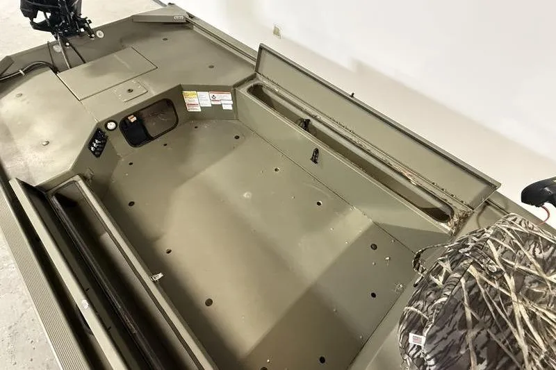 Slide: The Image of 2020 Tracker Grizzly 1548 T boat interior with storage compartments and camo seat. - 8