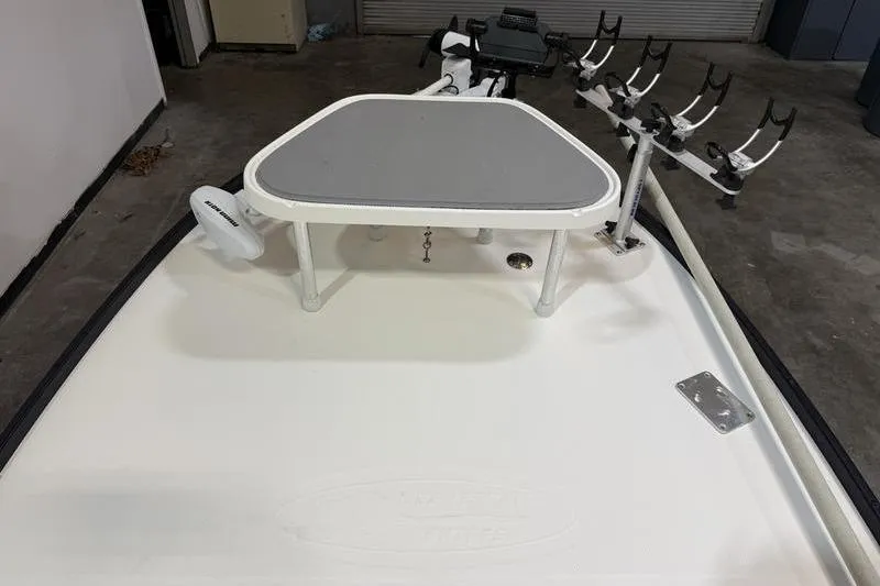 Slide: The Image of 2009 Beavertail Skiffs B2 boat deck with rod holders and trolling motor in a garage. - 10