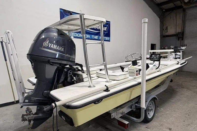 Slide: The Image of 2009 Beavertail Skiffs B2 with Yamaha engine in a garage setting. - 2