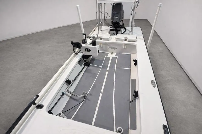 Slide: The Image of 2009 Beavertail Skiffs B2 boat interior with motor, spacious deck, and fishing equipment. - 5