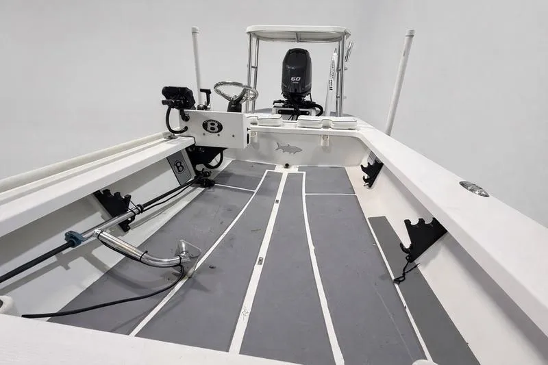 Slide: The Image of 2009 Beavertail Skiffs B2 interior with steering console and motor, showcasing sleek design. - 6