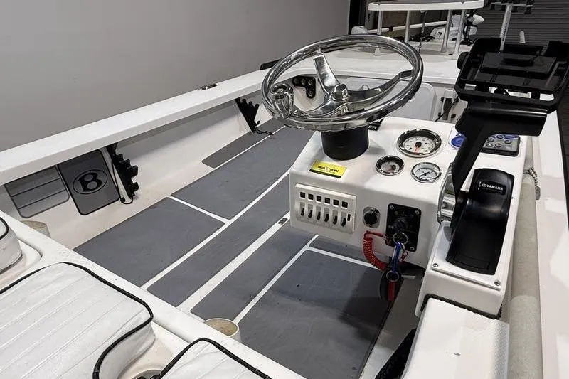 Slide: The Image of 2009 Beavertail Skiffs B2 boat interior with steering wheel and control panel. - 8