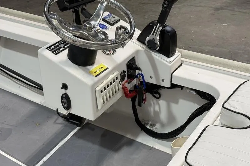 Slide: The Image of 2009 Beavertail Skiffs B2 boat console with steering wheel and controls. - 9