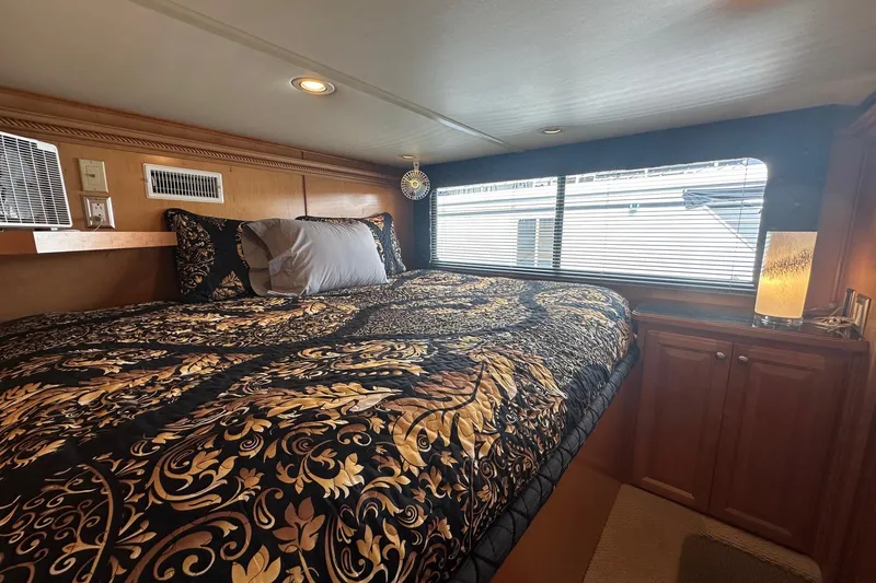 Slide: The Image of Luxurious bedroom interior in a 2004 Sumerset 16x82 houseboat with elegant bedding and ambient lighting. - 10