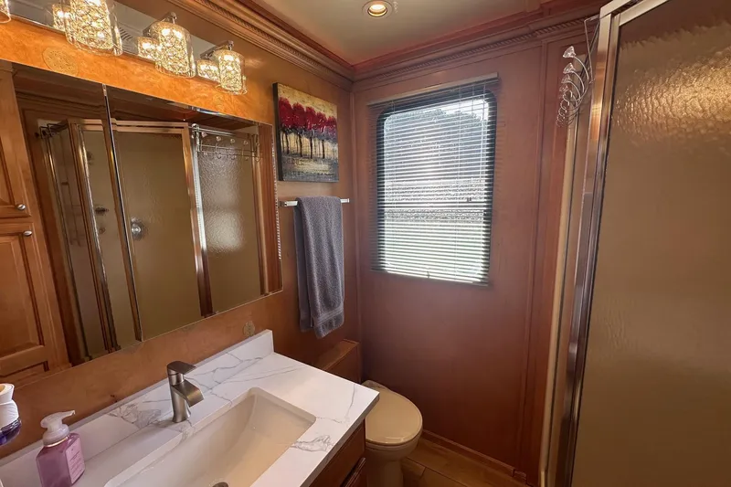 Slide: The Image of Luxurious bathroom in 2004 Sumerset 16x82 houseboat with modern fixtures and elegant decor. - 11