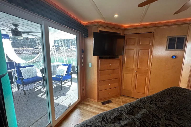 Slide: The Image of Luxurious 2004 Sumerset 16x82 houseboat interior with sliding glass doors and outdoor seating. - 13