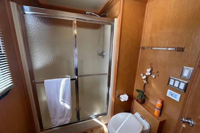 Slide: The Image of Bathroom in 2004 Sumerset 16x82 houseboat with shower, toilet, and decorative accents. - 15