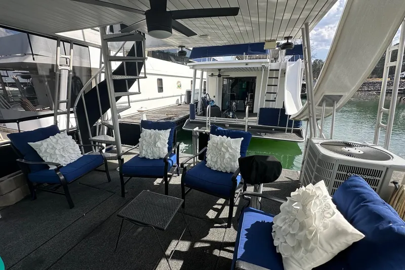 Slide: The Image of Luxurious 2004 Sumerset 16x82 houseboat with elegant outdoor seating and spiral staircase. - 17