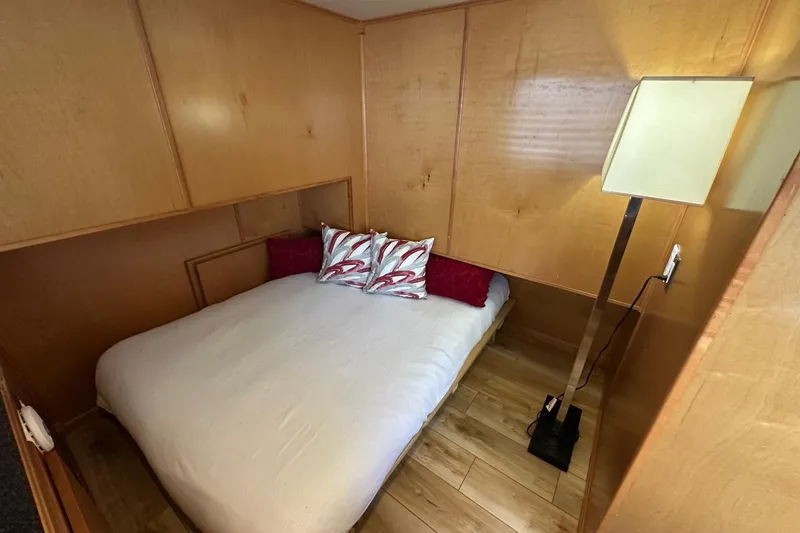 Slide: The Image of Cozy bedroom in 2004 Sumerset 16x82 houseboat with wooden walls and modern lamp. - 7