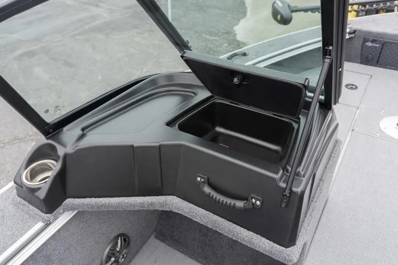Slide: The Image of 2026 G3 Angler V1750 SF boat storage compartment with open lid and cup holder. - 12