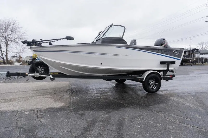 Slide: The Image of 2026 G3 Angler V1750 SF boat on trailer, parked on wet pavement. - 5
