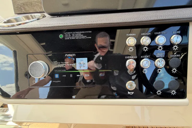 Slide: The Image of Control panel of 2020 Sea Ray Sundancer 320 Outboard with music display and buttons. - 11