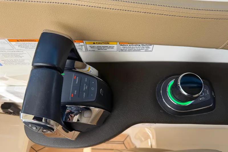 Slide: The Image of 2020 Sea Ray Sundancer 320 Outboard helm controls with throttle and joystick. - 12