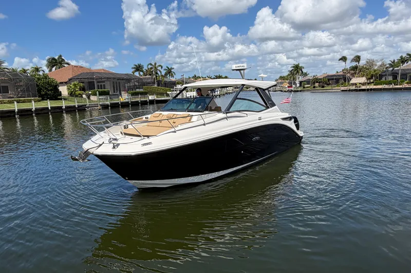 Slide: The Image of 2020 Sea Ray Sundancer 320 Outboard cruising on a sunny day in a scenic canal. - 3