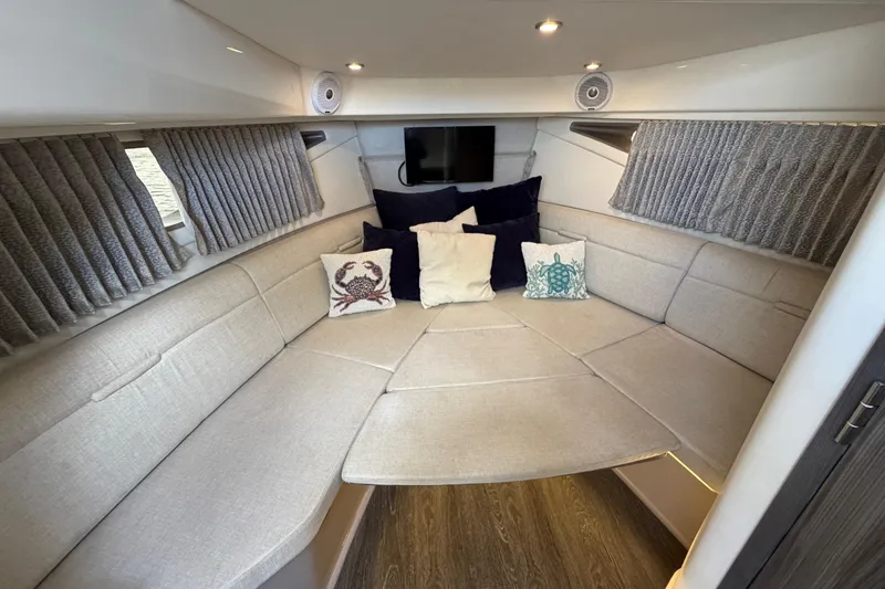 Slide: The Image of Interior of 2020 Sea Ray Sundancer 320 Outboard with cozy seating and decorative pillows. - 30