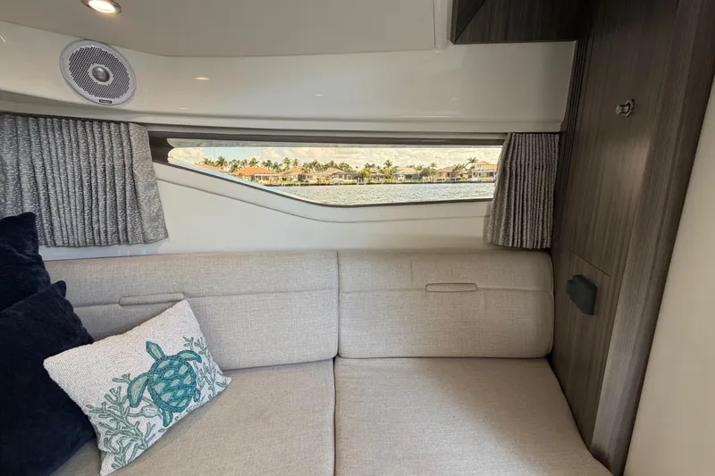 Slide: The Image of Interior of 2020 Sea Ray Sundancer 320 Outboard with cozy seating and decorative pillows. - 32