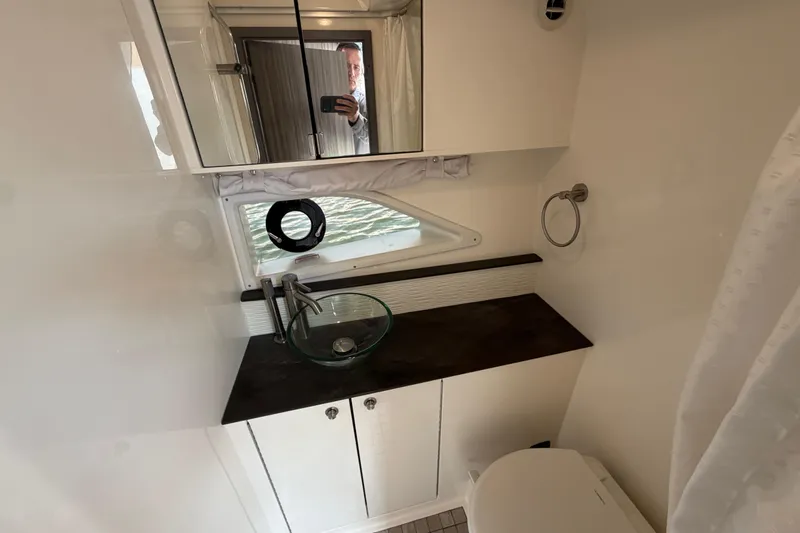 Slide: The Image of 2020 Sea Ray Sundancer 320 Outboard bathroom with modern sink and mirror. - 33