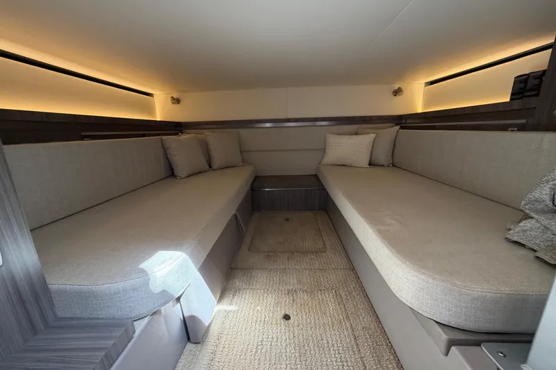 Slide: The Image of 2020 Sea Ray Sundancer 320 Outboard cabin interior with cozy seating and ambient lighting. - 34