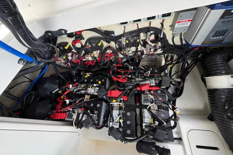 Slide: The Image of 2020 Sea Ray Sundancer 320 Outboard battery compartment with wiring and electrical components. - 41