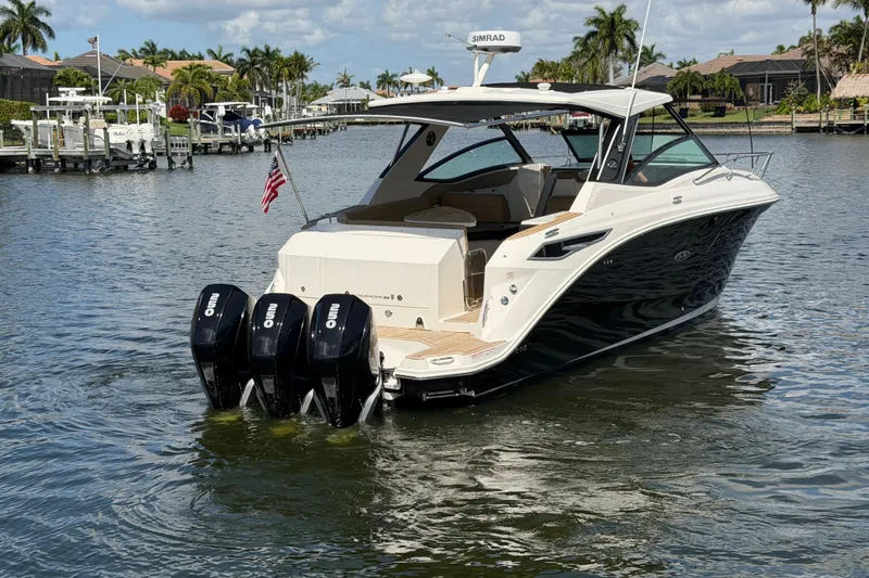 Slide: The Image of 2020 Sea Ray Sundancer 320 Outboard boat on water, featuring triple outboard engines. - 5