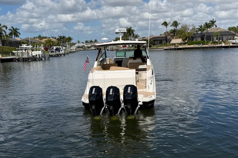 Slide: The Image of 2020 Sea Ray Sundancer 320 Outboard cruising on a scenic waterway with triple engines. - 6