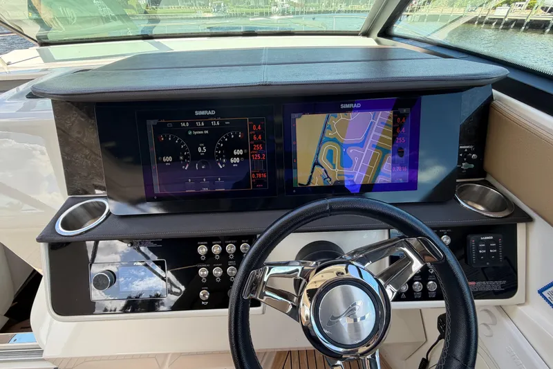 Slide: The Image of 2020 Sea Ray Sundancer 320 Outboard helm with Simrad navigation displays and controls. - 8