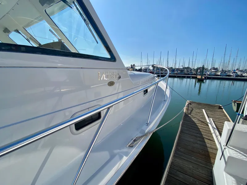 Slide: The Image of 2000 Mainship Pilot 34 at dock, sunny day. - 10