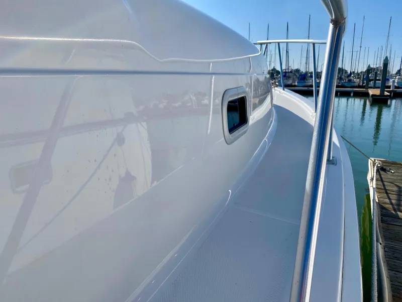 Slide: The Image of 2000 Mainship Pilot 34 docked, side view. - 11