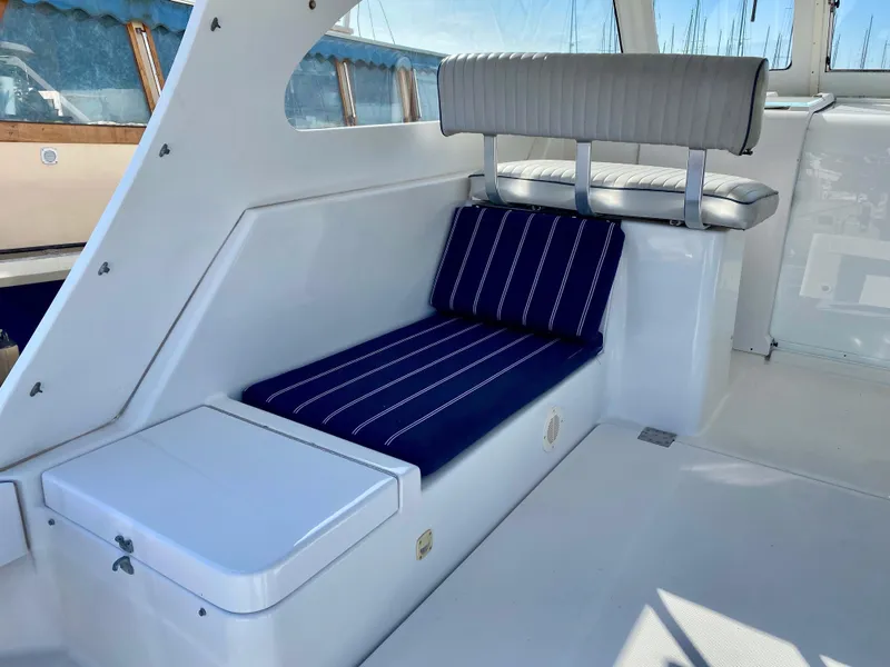 Slide: The Image of Interior of a 2000 Mainship Pilot 34 yacht with blue cushions. - 14