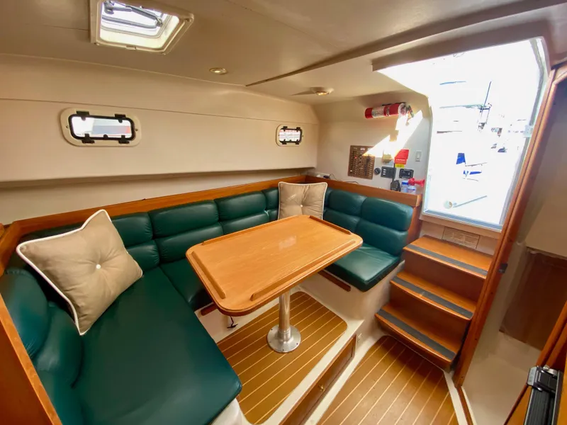 Slide: The Image of Interior of a 2000 Mainship Pilot 34 yacht with green upholstery. - 19