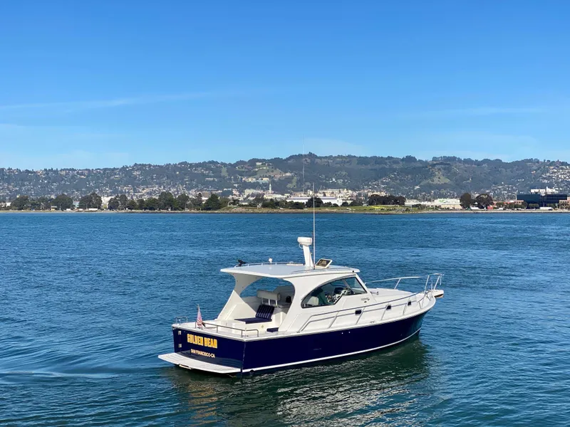 Slide: The Image of 2000 Mainship Pilot 34 boat cruising on calm waters. - 2