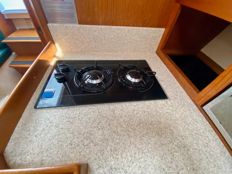 Slide: The Image of 2000 Mainship Pilot 34 kitchen area with gas stove. - 22