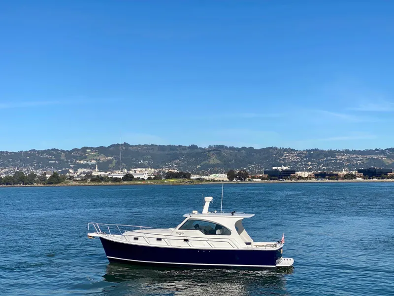 Slide: The Image of 2000 Mainship Pilot 34 boat on calm water. - 3