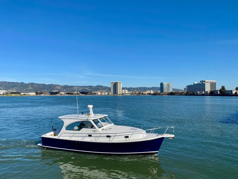 Slide: The Image of 2000 Mainship Pilot 34 boat on calm water. - 5