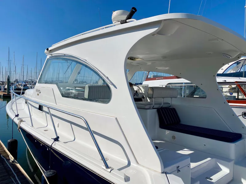 Slide: The Image of 2000 Mainship Pilot 34 boat docked in marina. - 9