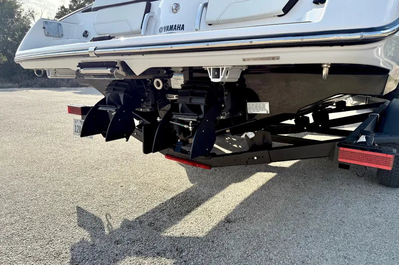 Slide: The Image of 2025 Yamaha Boats 252SE rear view showing dual engines and trailer. - 12