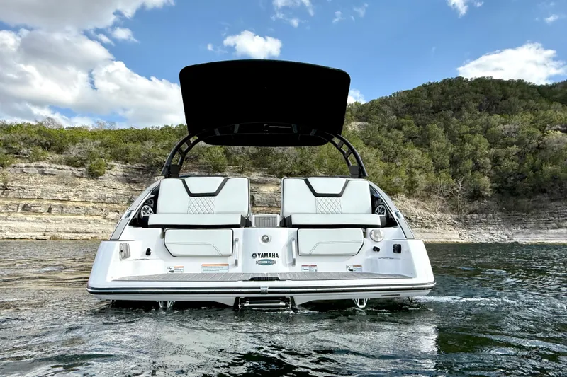 Slide: The Image of 2025 Yamaha Boats 252SE on water, scenic backdrop, clear sky. - 4