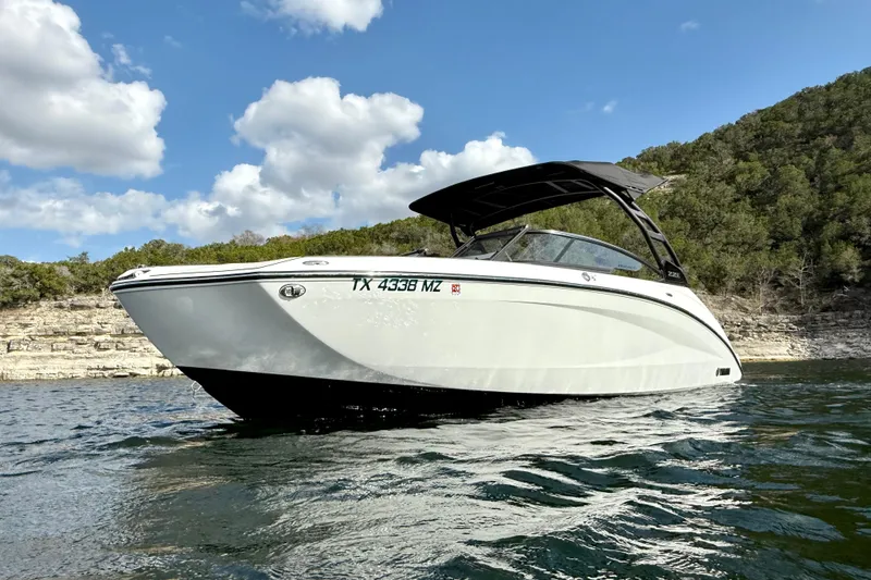 Slide: The Image of 2025 Yamaha Boats 252SE on water, scenic backdrop, clear sky, modern design. - 7