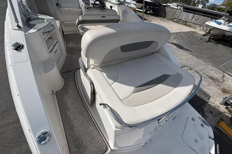 Slide: The Image of 2007 Chaparral Signature 250 boat interior with white seating and steering wheel. - 10