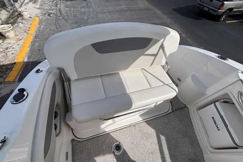 Slide: The Image of 2007 Chaparral Signature 250 boat interior with white seating and storage compartment. - 17